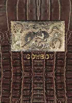 Cowboy: 7x10 lined notebook with antique horse belt buckle on brown leather background
